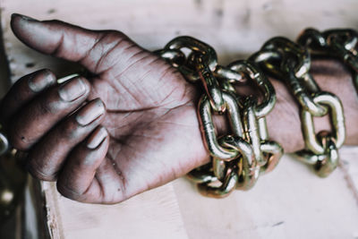 Close-up of human hand on metal