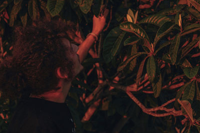 Close-up portrait of man standing by tree