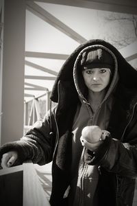 Portrait of woman holding mask in winter