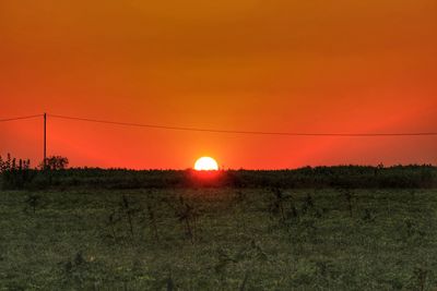 Scenic view of field against sky during sunset