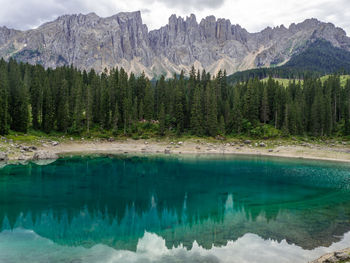 Scenic view of lake carezza in dolomites with mountains reflectin in water 
