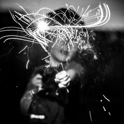 Boy holding sparkler at night