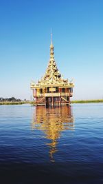 Golden temple reflected on lake in myanmar