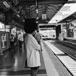 Woman standing on railroad station platform