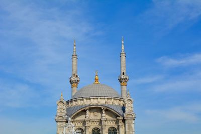 Low angle view of mosque against blue sky