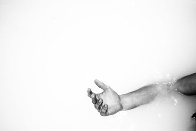 Close-up of hands against white background