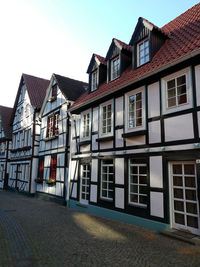 Houses by street against sky in town