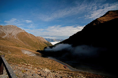 Scenic view of mountains against cloudy sky