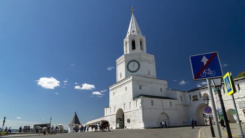 View of buildings in city against blue sky