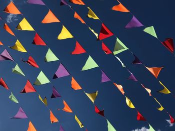 Low angle view of multi colored umbrellas hanging on paper