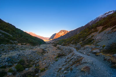 Scenic view of mountains against clear blue sky