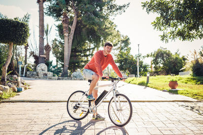 Man riding bicycle on footpath