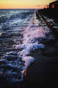Close-up of sea against sky during sunset