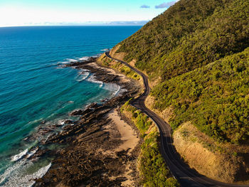 Scenic view of sea by mountain