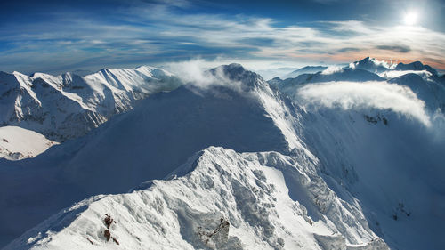 Scenic view of snowcapped mountains against sky