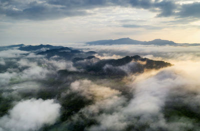 Beautiful fog in the morning forest with green mountains. pang puay, mae moh, lampang, thailand.