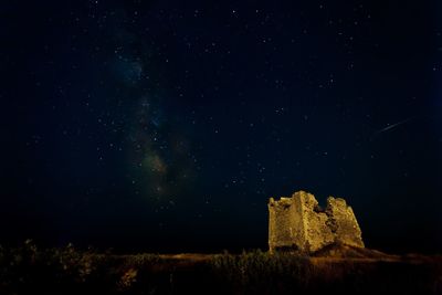 Low angle view of historic building against sky at night