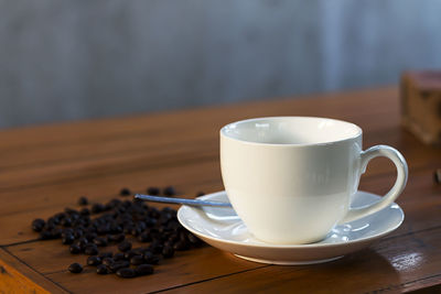 High angle view of coffee cup on wooden table