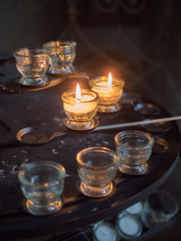 Close-up of lit tea light candles on table