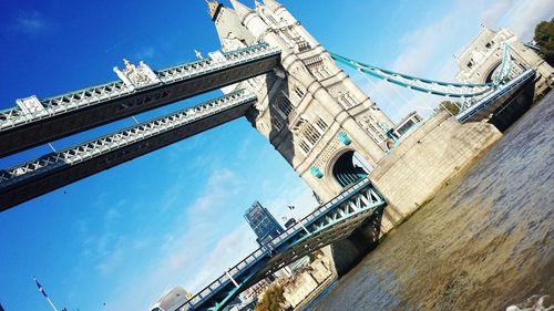 Low angle view of suspension bridge against sky