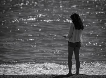 Full length of teenage girl standing at beach