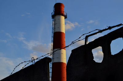 Low angle view of smoke stack against sky