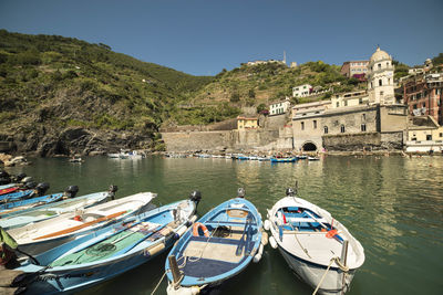 Boats on river with buildings in background