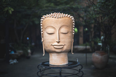 Close-up of buddha statue in park