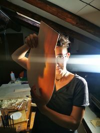 Portrait of woman standing by restaurant