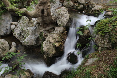 View of waterfall along rocks