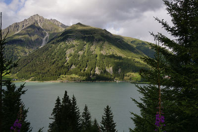 Scenic view of lake against cloudy sky