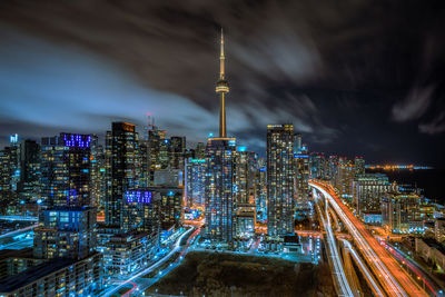 Illuminated cityscape against sky at night