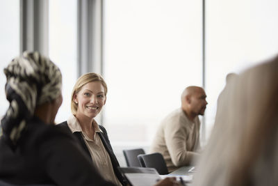 Smiling businesswoman at business meeting