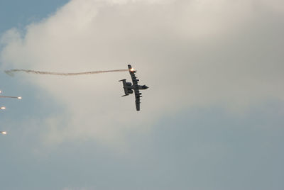 Low angle view of airplane flying against sky