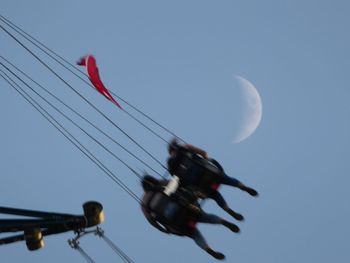 Low angle view of helicopter against clear sky