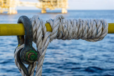 Close-up of rope tied on railing