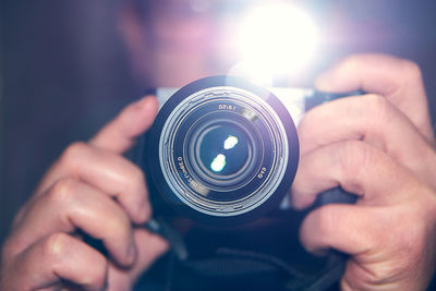 Midsection of person holding camera