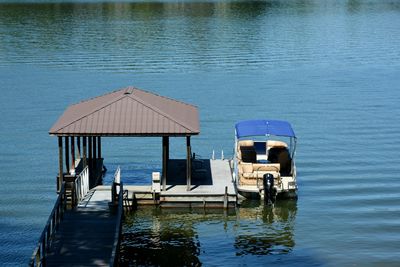  high angle view of pontoon boat along side dock in lake