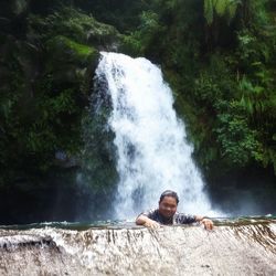 Man standing on rocks in forest