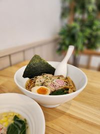 Close-up of ramen in a bowl on a table. 