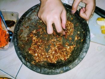 High angle view of person preparing food on table