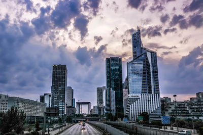 Modern buildings against cloudy sky