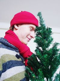 Portrait of woman with red christmas tree in winter