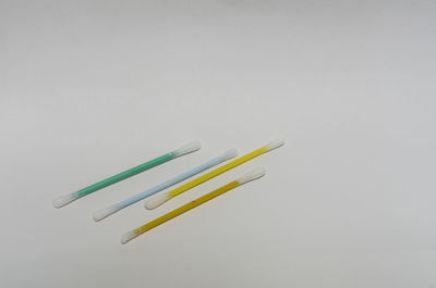 High angle view of colored pencils against white background