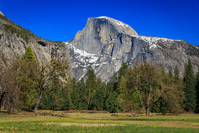 Scenic view of mountains against clear blue sky