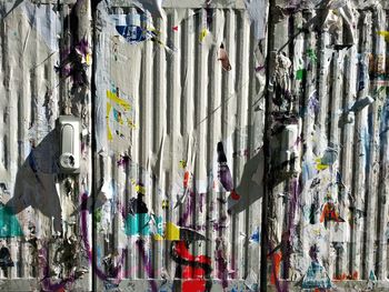 Close-up of torn posters on wall