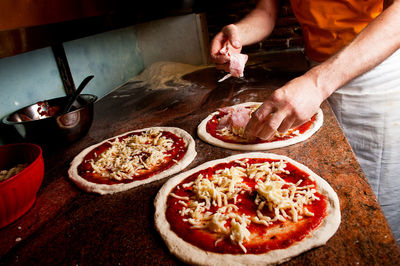 Midsection of man preparing food at restaurant