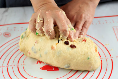 Home pastry chef kneading of the dough for making artisan fruit bread or panettone