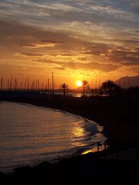 Scenic view of lake against romantic sky at sunset