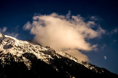 Scenic view of snow covered mountains against sky